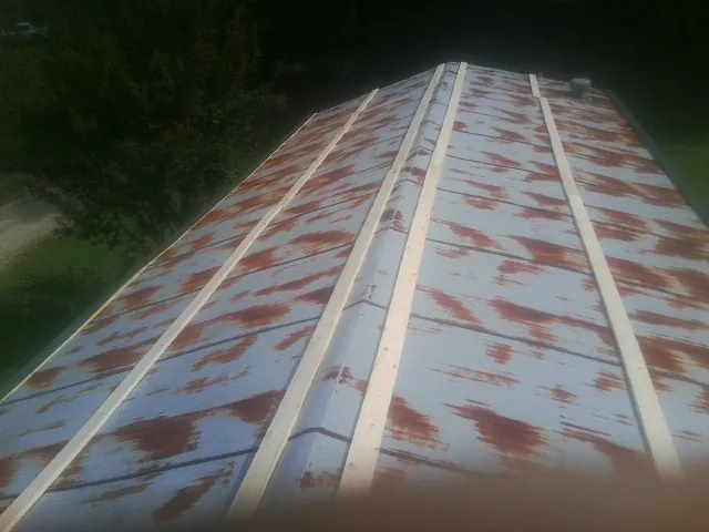 Rusted metal roof panels with new wood purlins before replacement — Storm Damage Roof Repair in Clarion by Roofing Brothers