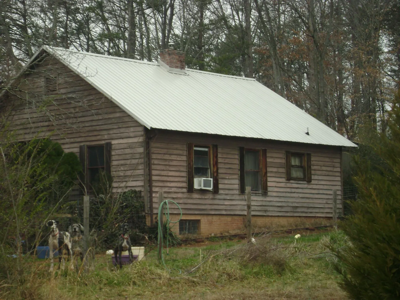 White metal roof on an old wood sided farmhouse, from a Metal Roof Installation job in Clarion
